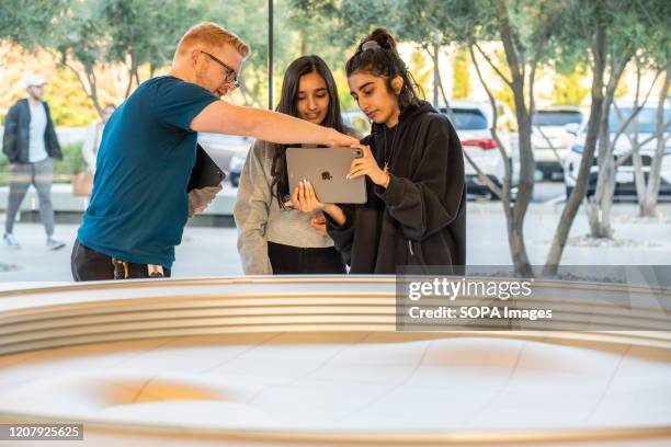 Customers use an iPad for an augmented reality tour to see a virtual version of the Apple Park campus at the Apple Park Visitor Center in Cupertino.