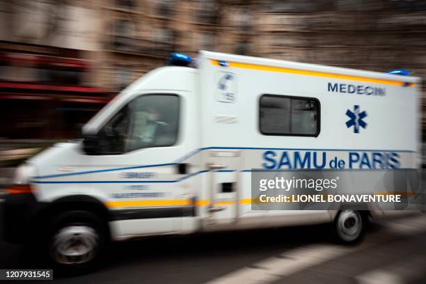 Samu emergency service's ambulance rushes out of the La Pitie-Salpetriere hospital in Paris on March 21 on the fifth day of a strict nationwide...