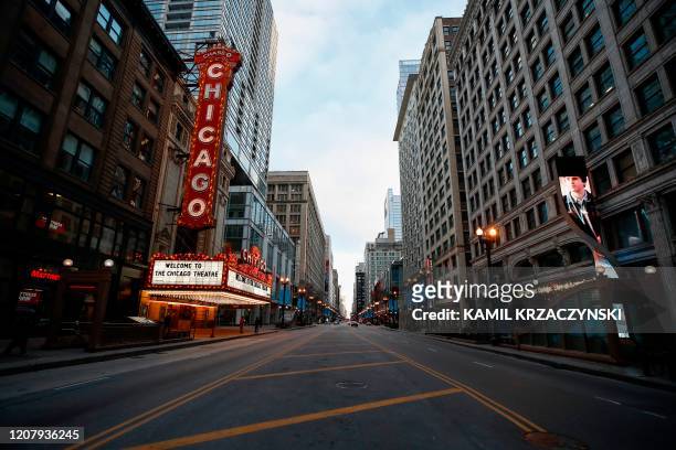 Closed Chicago Theatre is seen in Chicago, Illinois, on March 21, 2020. - Almost one billion people were confined to their homes worldwide Saturday...