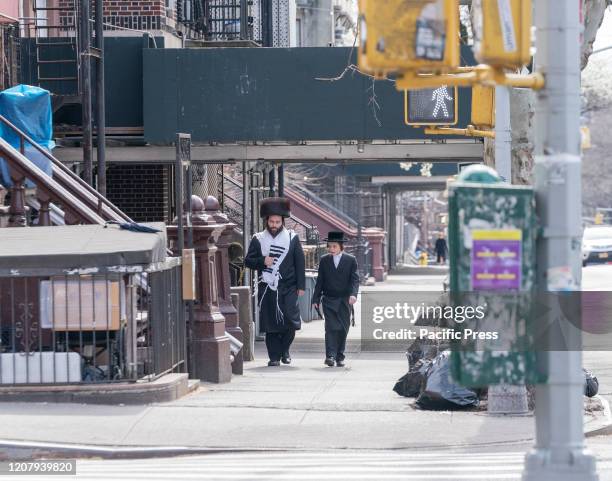 Hasidic Satmar Jewish men walking on streets during Coronavirus outbreak in Williamsburg neighborhood of Brooklyn.