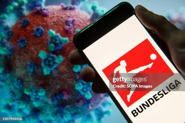 In this photo illustration the German professional association football league Bundesliga logo seen displayed on a smartphone with a computer model...