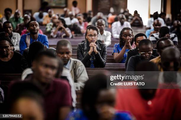 Catholics pray during a sermon talking about COVID-19 coronavirus during a Sunday Mass at Holy Family Minor Basilica in Nairobi, Kenya on March 22,...