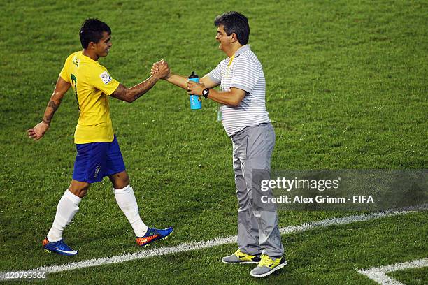 Dudu of Brazil celebrates his team's third goal with head coach Ney Franco during the FIFA U-20 World Cup 2011 round of 16 match between Brazil and...