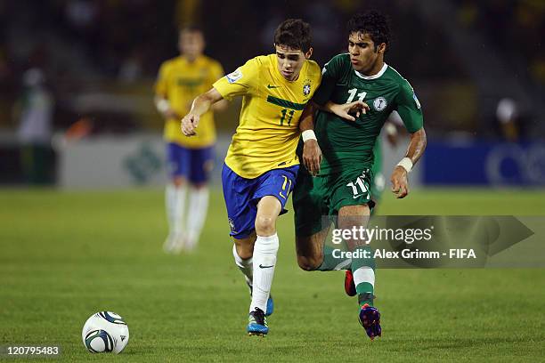 Oscar of Brazil is challenged by Ibrahim Alibrahim of Saudi Arabia during the FIFA U-20 World Cup 2011 round of 16 match between Brazil and Saudi...