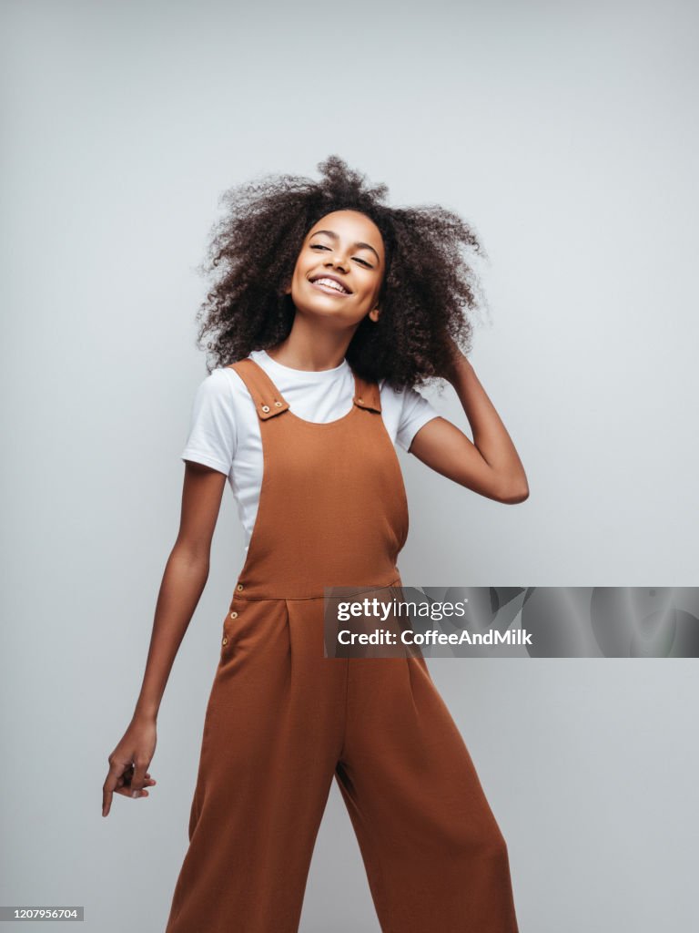 Beautiful smiling girl with curly hairstyle