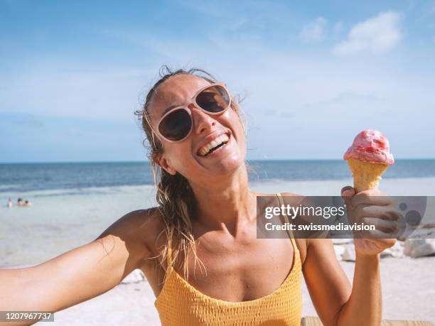 selfie of happy woman on beach eating ice cream - woman ice cream stock pictures, royalty-free photos & images