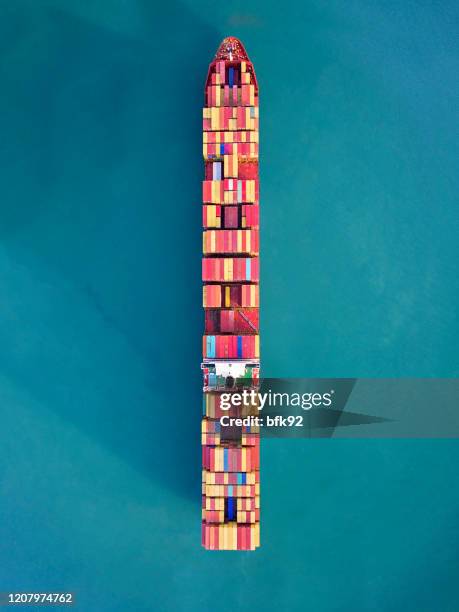 aerial view of container freight ship carrying container box for import and export business logistic in ocean. - pacific ocean trade stock pictures, royalty-free photos & images