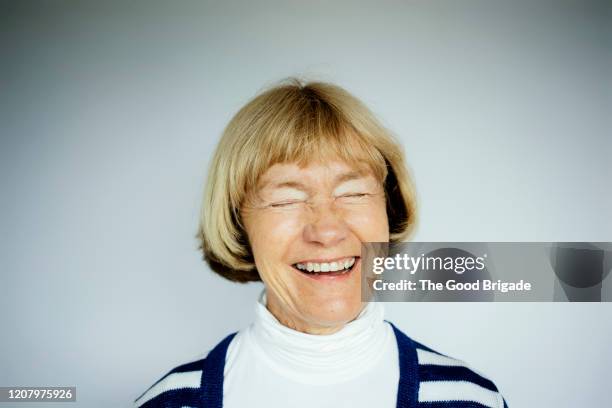 portrait of happy senior woman on white background - old womans face stock pictures, royalty-free photos & images