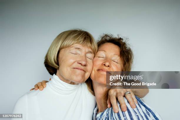 portrait of mother and daughter on white background - due facce foto e immagini stock