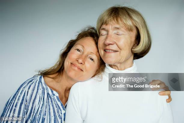 portrait of mother and daughter on white background - woman unique features stock-fotos und bilder