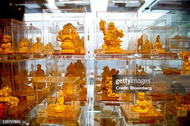 Gold figurines are displayed at Beijing Caibai precious metals and jewelry store in Beijing, China, on Thursday, Aug. 11, 2011. Gold extended a rally...