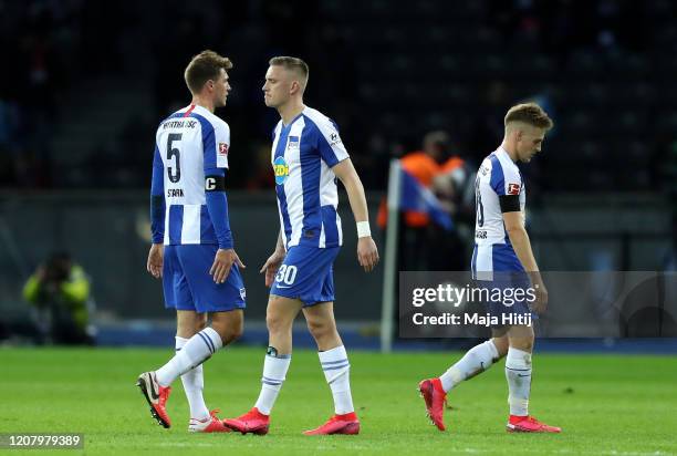 Niklas Stark of Hertha BSC, Marius Wolf and Santiago Ascacibar looks dejected following their sides defeat in during the Bundesliga match between...
