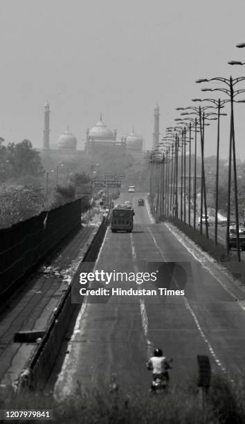 Monochrome view of an empty stretch of road with the Jama Masjid visible in the background from Geeta Colony area, on March 22, 2020 in New Delhi,...