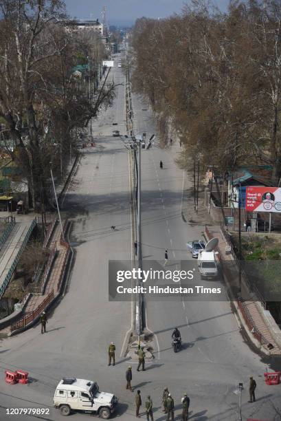 Paramilitary soldiers stand guard on a deserted street during Janta Curfew, on March 22, 2020 in Srinagar, India. PM Modi proposed a 'Janata curfew'...