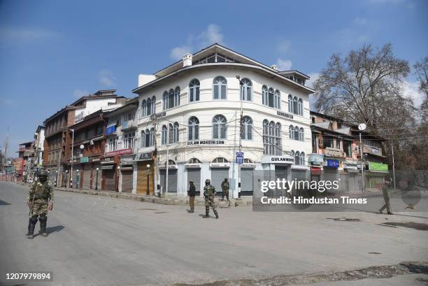 Paramilitary soldiers stand guard on a deserted street during Janta Curfew, on March 22, 2020 in Srinagar, India. PM Modi proposed a 'Janata curfew'...