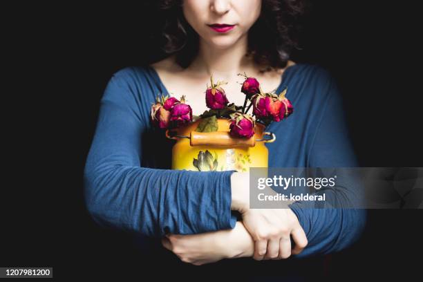 woman holding wilted roses - wilted plant stock pictures, royalty-free photos & images
