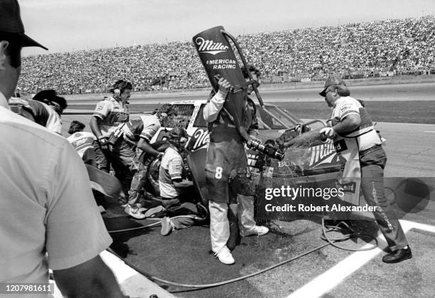 Driver Bobby Allison is serviced by his crew members during a pit stop at the 1987 Pepsi Firecracker 400 race at Daytona International Speedway in...