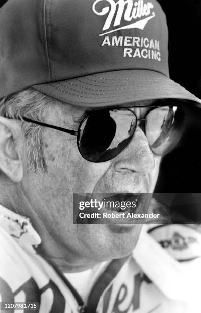 Driver Bobby Allison talks with friends in the speedway garage prior to the start of the 1987 Pepsi Firecracker 400 race at Daytona International...