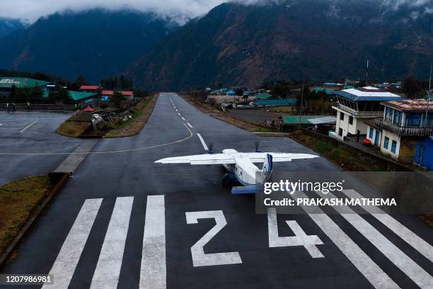 Private aircraft prepares to take off form the Tenzing-Hillary Airport in Lukla, some 140 kilometres northeast of Kathmandu, following travel...