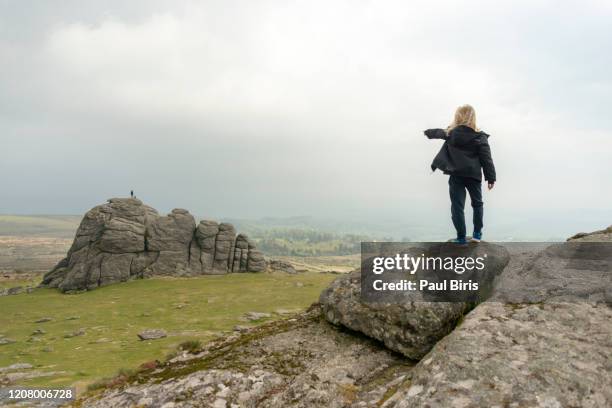 boy pointing the haytor rocks on dartmoor,  south west england, united kingdom - devon stock pictures, royalty-free photos & images