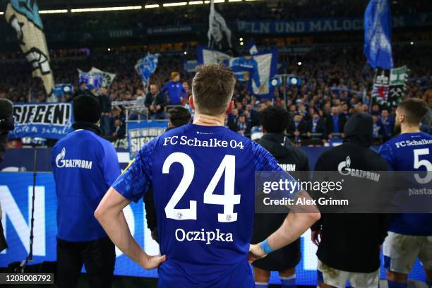Bastian Oczipka of FC Schalke 04 apologise to the fans after the Bundesliga match between FC Schalke 04 and RB Leipzig at Veltins-Arena on February...