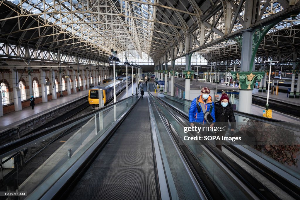 Two people wearing face masks as preventive measure against...