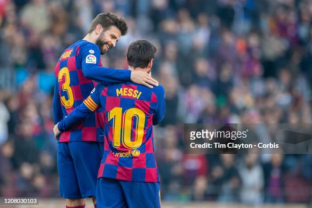 February 22: Gerard Pique of Barcelona congratulates Lionel Messi of Barcelona after he completed his first half hat trick of goals during the...