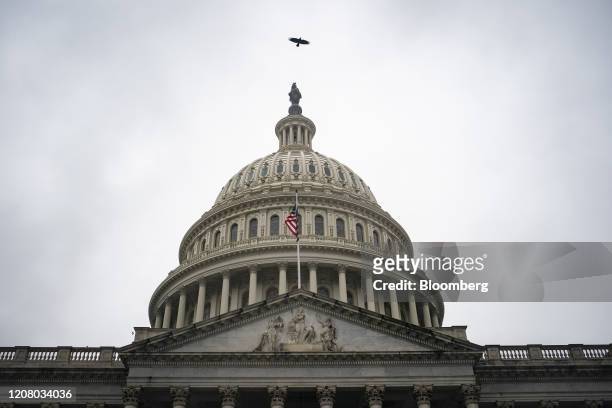 Bird flies over the U.S. Capitol in Washington, D.C., U.S., on Monday, March 23, 2020. U.S. Senators in both political parties expressed confidence...