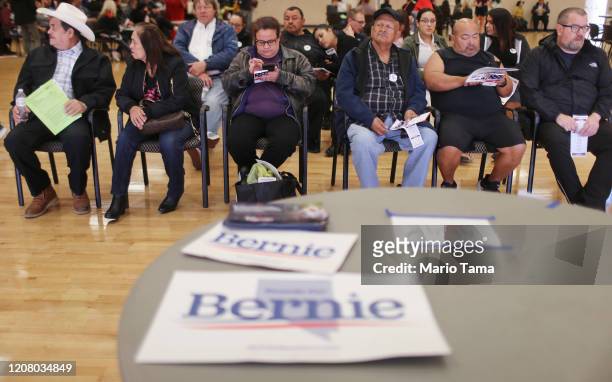 Caucus goers sit near campaign signs for Democratic presidential candidate Sen. Bernie Sanders at a Democratic presidential caucus site at East Las...