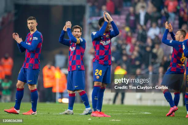 February 22: Clement Lenglet of Barcelona, Lionel Messi of Barcelona, Junior Firpo of Barcelona and Arthur of Barcelona applaud the supporters at the...