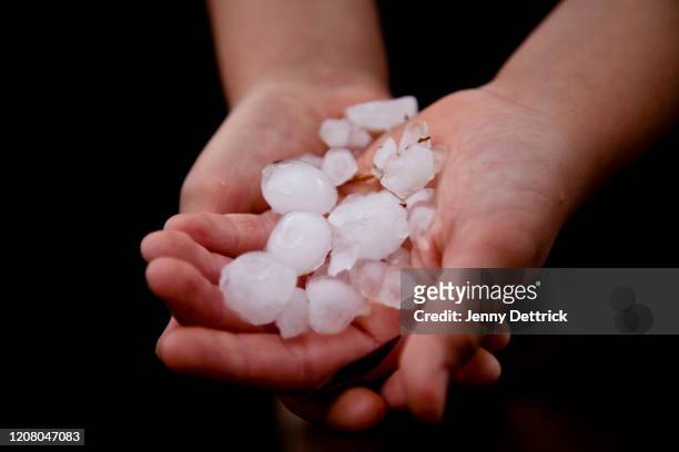 child's hands holding hail - hailstorm stock pictures, royalty-free photos & images