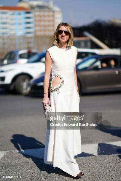 Lisa Aiken wears sunglasses, a white sleeveless dress, outside MSGM, during Milan Fashion Week Fall/Winter 2020-2021 on February 22, 2020 in Milan,...