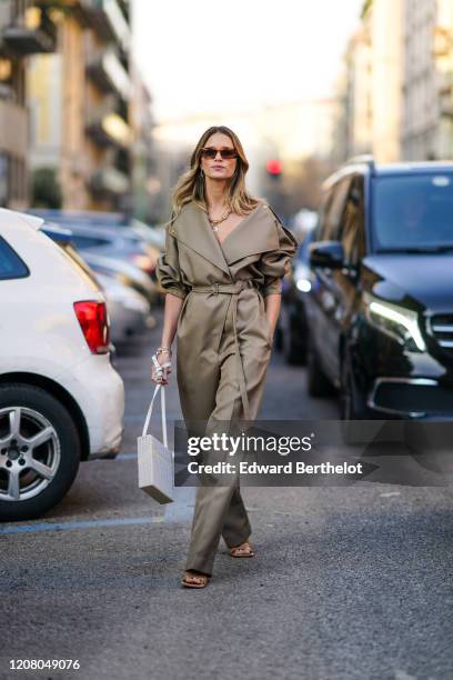 Helena Bordon wears sunglasses, a jumpsuit, a white rectangular bag, outside Bottega Veneta, during Milan Fashion Week Fall/Winter 2020-2021 on...