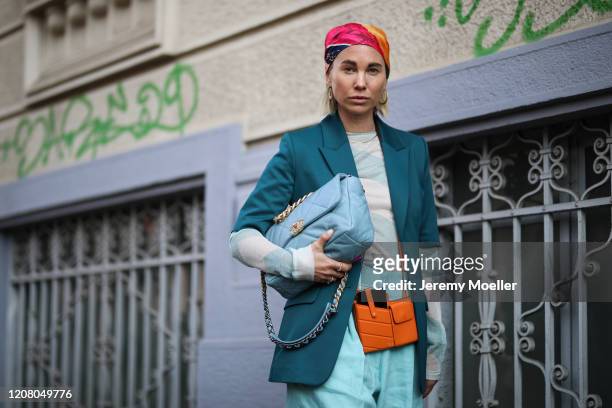 Karin Teigl is seen wearing a Fendi and Chanel bag, H&M hair band and a blue short during Milan Fashion Week Fall/Winter 2020-2021 on February 22,...