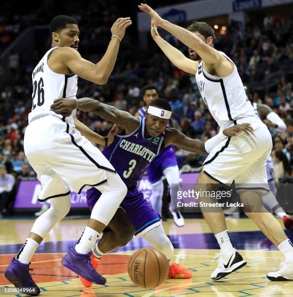 Teammates Spencer Dinwiddie and Joe Harris of the Brooklyn Nets try to stop Terry Rozier of the Charlotte Hornets during their game at Spectrum...