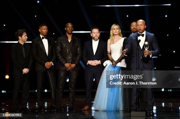 Tim Blake Nelson, Jamie Foxx, Rob Morgan, producer Asher Goldstein, Brie Larson, Michael B. Jordan, and writer Bryan Stevenson accept the Outstanding...