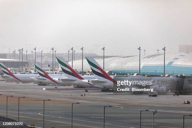 An Airbus SE A380-800 aircraft, right, stands alongside a line of Boeing Co. 777-300 aircraft, operated by Emirates, at Dubai International Airport...