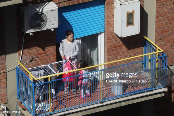 Woman plays with her daughter on the balcony of their home during lockdown on March 23, 2020 in Rome, Italy. As Italy extends its nationwide lockdown...