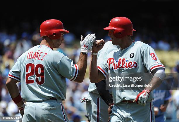 Raul Ibanez congratulates teammate Hunter Pence of the Philadelphia Phillies after hitting a two run homerun in the fourth inning against the Los...