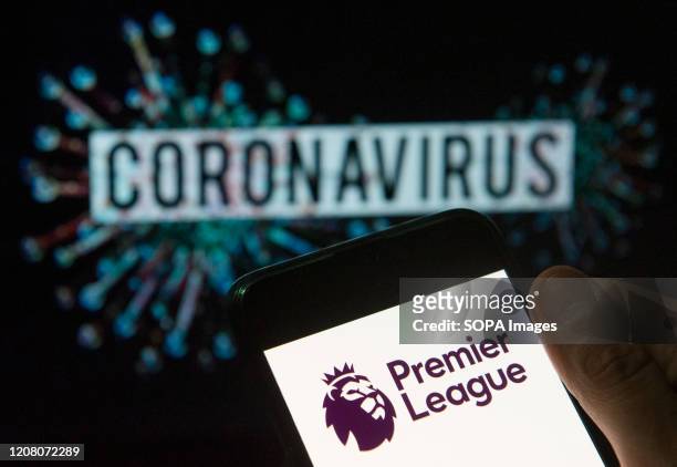 In this photo illustration the top level of the English football league Premier League logo seen displayed on a smartphone with a computer model of...