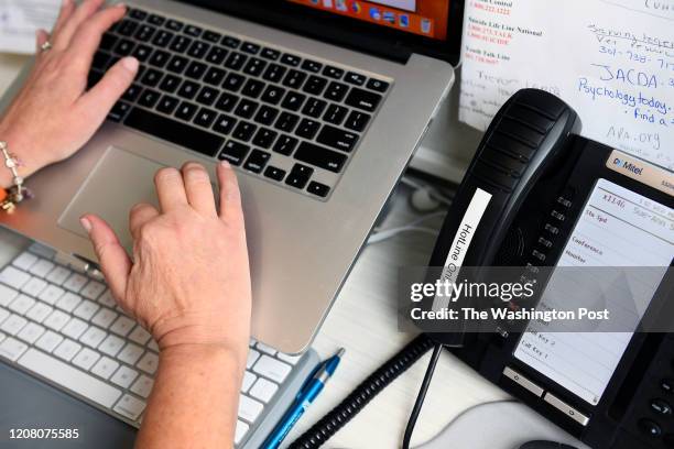 Sue-Ann Siegel logs in a summary of a call to the Montgomery County Hotline from her home office March 18, 2020 in Chevy Chase, MD. The covid-19...