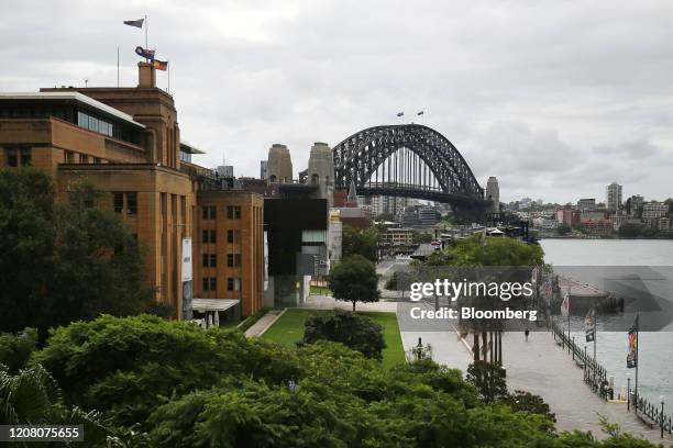 Pedestrian walks through a near-empty Circular Quay in Sydney, Australia, on Tuesday, March 24, 2020. Australia's parliament rushed through more than...