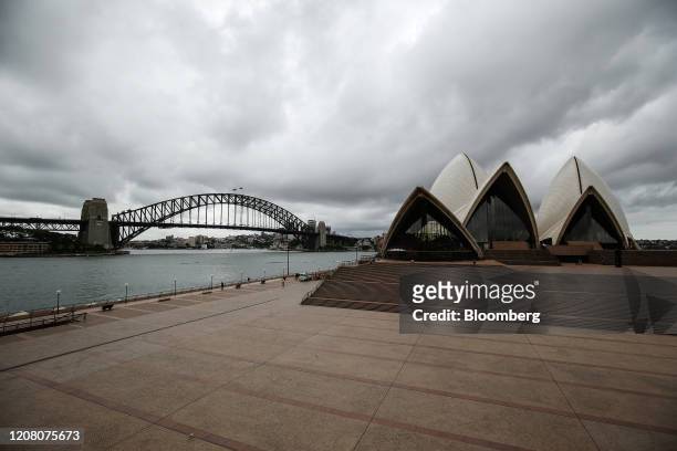 The Sydney Harbour Bridge stands across from the closed Sydney Opera House in Sydney, Australia, on Tuesday, March 24, 2020. Australia's parliament...
