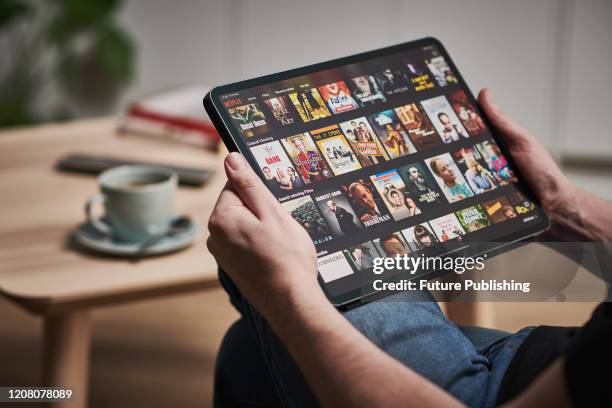 Detail of a man watching Netflix on an Apple iPad Pro, taken on March 6, 2020.