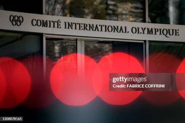 Picture taken on March 24, 2020 of the entrance of the headquarters of the International Olympic Committee in Lausanne. - Japanese Prime Minister is...