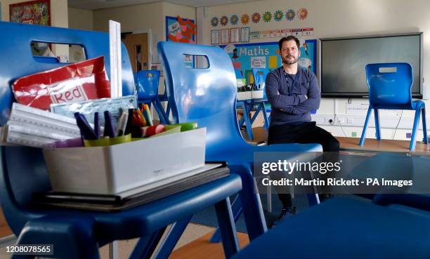 Simon Cotterill, Head Teacher of Manor Park School and Nursery in Knutsford Cheshire, sits in an empty classroom, the day after Prime Minister Boris...