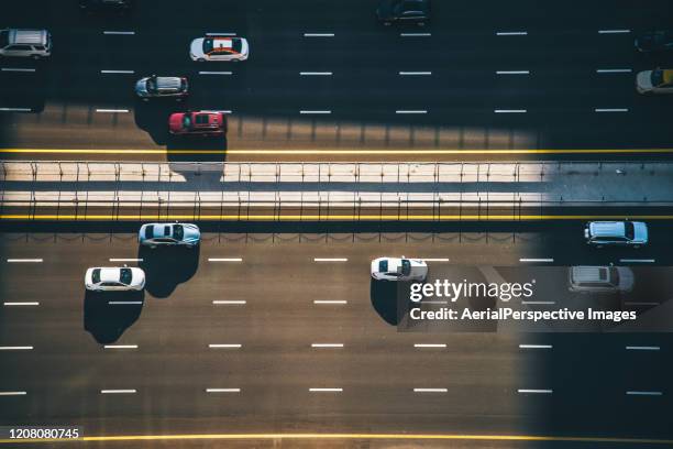 drone point view, dubai city traffic on a highway - highway patrol stock-fotos und bilder