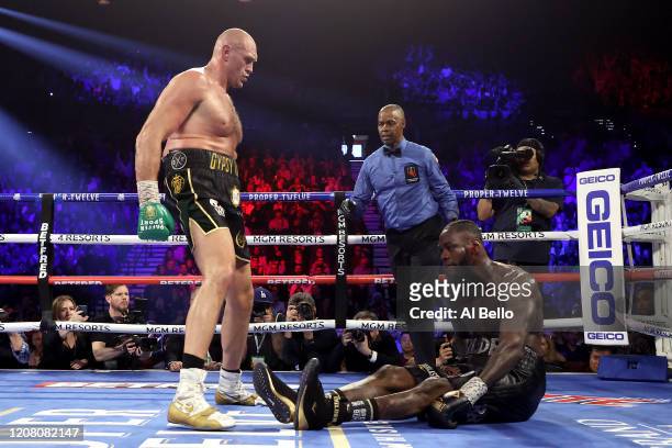 Tyson Fury knocks down Deontay Wilder in the fifth round during their Heavyweight bout for Wilder's WBC and Fury's lineal heavyweight title on...