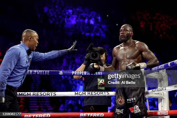 Referee Kenny Bayless sends Deontay Wilder to his corner during the Heavyweight bout for Wilder's WBC and Fury's lineal heavyweight title against...