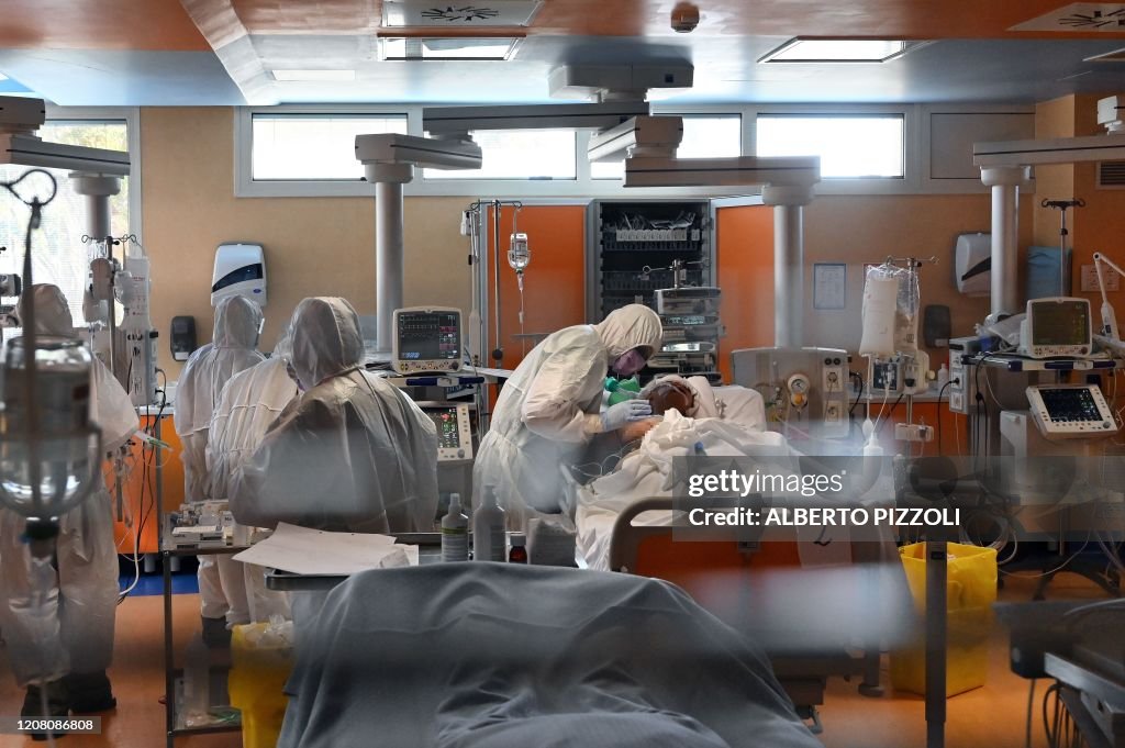 A medical worker in protective gear tends to a patient on March 24 ...